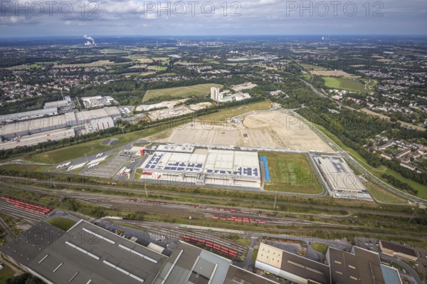 Aerial view, construction site with the new REWE logistics centre on Walzwerkstraße at the old Westfalenhütte in the Borsigplatz district of Dortmund, Ruhr area, North Rhine-Westphalia, Germany, construction area, building site, building plots, construction project, construction site, brownfield site, DE, Dortmund, Europe, commercial enterprises, commercial area, commercial area, commercial location, commercial use, industrial area, industrial location, logistics, logistics service, logistics service provider, logistics provider, logistics centre, aerial view, aerial photography, aerial photography, new construction, transport service, overview, bird's-eye view, overview