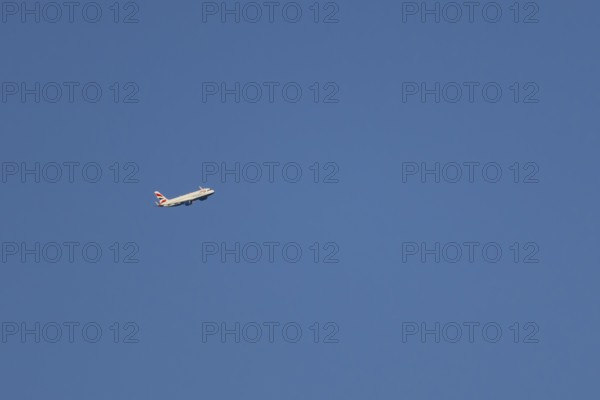 Airbus A320-232 jet passenger aircraft of British Airways airlines in flight in a blue sky, London, England, United Kingdom