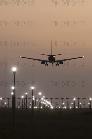 Boeing 737 jet aircraft of Ryanair airlines in flight landing at sunset at London Stansted airport, Essex, England, United Kingdom