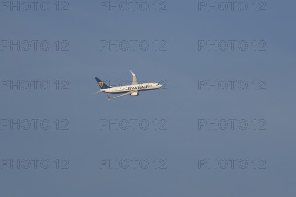 Boeing 737 jet passenger aircraft of Ryanair airlines in flight in a blue sky, Rome, Italy