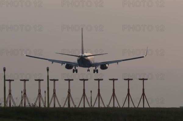 Boeing 737 jet aircraft of Ryanair airlines in flight landing at sunset at London Stansted airport, Essex, England, United Kingdom