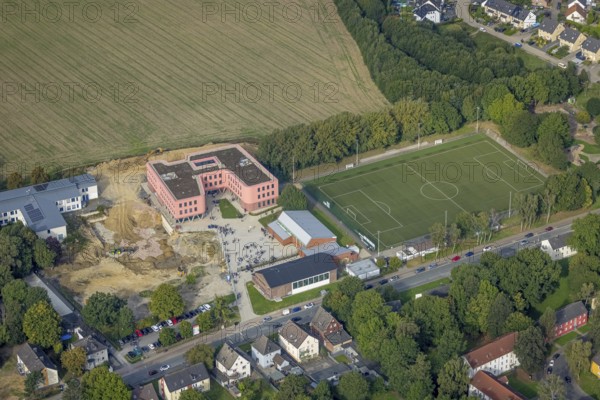 Aerial view, Pink building of the Reinoldi comprehensive school and construction site in the Bodelschwingh district of Dortmund, Ruhr area, North Rhine-Westphalia, Germany, construction work, construction area, construction site, building plots, construction project, construction site, educational institution, DE, Dortmund, Europe, comprehensive school, teaching institute, aerial photograph, aerial photography, aerial photography, new building, school, overview, bird's eye view, bird's eye view, overview