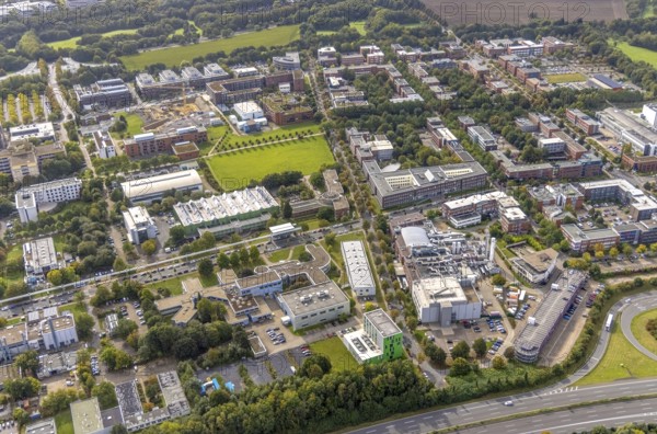 Aerial view of TZDO - TechnologieZentrumDortmund GmbH, Technische Universität Dortmund Campus Nord with the Technology Centre and EMC Test North Rhine-Westphalia GmbH EMC Competence Centre and construction site for the CALEDO research centre next to the Faculty of Computer Science in the Oespel district of Dortmund, Ruhr area, North Rhine-Westphalia, Germany, A40 motorway, construction work, construction site, building plots, building avenue, construction project, building site, education, educational institution, Campus North, DE, Dortmund, Elmos Semiconductor SE, Emil-Figge-Straße, Europe, distant view, green area technology park, aerial view, aerial photograph, aerial photography, aerial photography, new building, TU Dortmund, Dortmund University of Technology, overview, University of Dortmund, bird's-eye view, overview