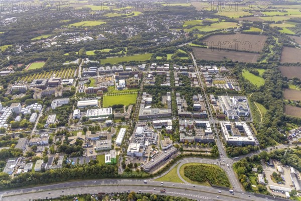 Aerial view of the TZDO - TechnologieZentrumDortmund GmbH, Technical University Dortmund Campus North with the Technology Centre and EMC Test North Rhine-Westphalia GmbH EMC Competence Centre as well as construction site for the CALEDO research centre next to the Faculty of Computer Science in the Oespel district of Dortmund, Ruhr area, North Rhine-Westphalia, Germany, A40 motorway, construction work, construction site, building plots, construction avenue, construction measure, construction project, construction site, education, educational institution, north campus, south campus, DE, Dortmund, Elmos Semiconductor SE, Emil-Figge-Straße, Europe, distant view, green area technology park, aerial view, aerial photograph, aerial photography, aerial photography, new building, TU Dortmund, Dortmund University of Technology, overview, University of Dortmund, bird's-eye view, overview