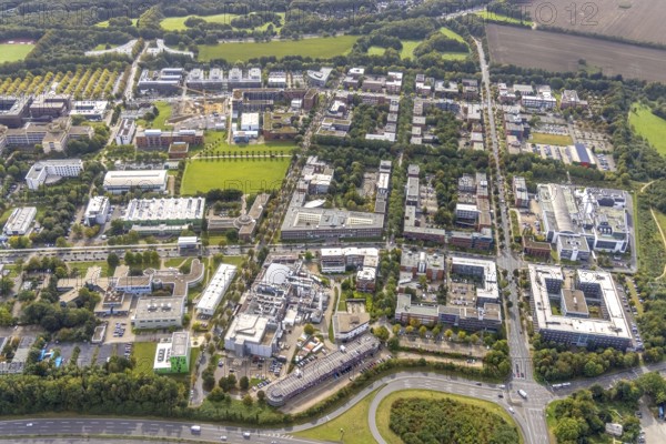 Aerial view of TZDO - TechnologieZentrumDortmund GmbH, Technische Universität Dortmund Campus Nord with the Technology Centre and EMC Test North Rhine-Westphalia GmbH EMC Competence Centre and construction site for the CALEDO research centre next to the Faculty of Computer Science in the Oespel district of Dortmund, Ruhr area, North Rhine-Westphalia, Germany, A40 motorway, construction work, construction site, building plots, building avenue, construction project, building site, education, educational institution, Campus North, DE, Dortmund, Elmos Semiconductor SE, Emil-Figge-Straße, Europe, distant view, green area technology park, aerial view, aerial photograph, aerial photography, aerial photography, new building, TU Dortmund, Dortmund University of Technology, overview, University of Dortmund, bird's-eye view, overview