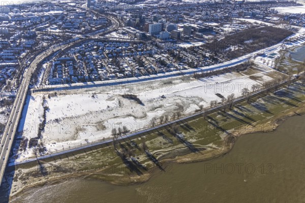 Aerial view, ice rink, ice skaters and pedestrians on frozen Rhine meadow in Lörrick near the Theodor-Heuss-Bridge, Niederkassel, Düsseldorf, Rhineland, North Rhine-Westphalia, Germany, DE, Europe, shapes and colours, aerial view, aerial photography, aerial photography, ice skating, snow, overview, bird's eye view, winter, birds-eyes view, overview