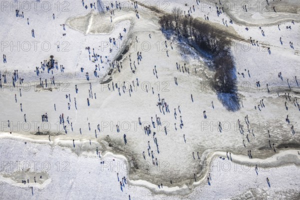 Aerial view, ice rink, ice skaters and pedestrians on frozen Rhine meadow in Lörrick near the Theodor-Heuss-Bridge, Niederkassel, Düsseldorf, Rhineland, North Rhine-Westphalia, Germany, DE, Europe, shapes and colours, aerial view, aerial photography, aerial photography, ice skating, snow, overview, bird's eye view, winter, birds-eyes view, overview