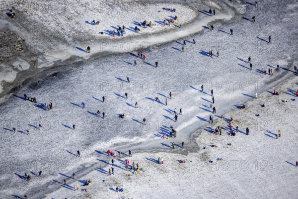 Aerial view, ice rink, ice skaters and pedestrians on frozen Rhine meadow in Lörrick near the Theodor-Heuss-Bridge, Niederkassel, Düsseldorf, Rhineland, North Rhine-Westphalia, Germany, DE, Europe, shapes and colours, aerial view, aerial photography, aerial photography, ice skating, snow, overview, bird's eye view, winter, birds-eyes view, overview