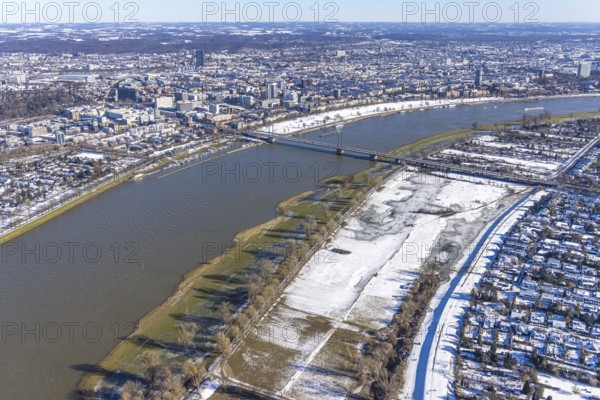 Aerial view, ice rink, ice skaters and pedestrians on frozen Rhine meadow in Lörrick near the Theodor-Heuss-Bridge, river Rhine, Niederkassel, Düsseldorf, Rhineland, North Rhine-Westphalia, Germany, DE, Europe, shapes and colours, aerial view, aerial photography, aerial photography, ice skating, snow, overview, bird's eye view, winter, birds-eyes view, overview