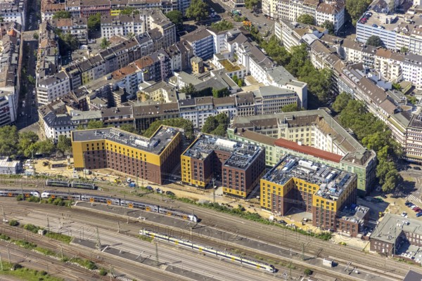 Aerial view, construction site and new hotel buildings for Adina Apartment Hotel, Hampton by Hilton and Premier Inn at Düsseldorf Hbf Stadtmitte in Düsseldorf, Rhineland, North Rhine-Westphalia, Germany, railway tracks, railway station, construction work, construction area, building site, building plots, construction crane, construction measure, construction project, construction site, DE, Deutsche Bahn AG, Düsseldorf, Düsseldorf main station, development, Europe, Düsseldorf-Mettmann tax office, gastronomy, main station, main railway station, hotel, hotel facilities, hotel industry, capacity requirements, aerial view, aerial photography, aerial photography, new construction, overview, bird's-eye view, overview