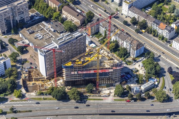 Aerial view, construction site and new construction of the three-storey Eclipse high-rise building next to the Hilton Hotel on Kennedydamm in the Golzheim district, Düsseldorf, Rhineland, North Rhine-Westphalia, Germany, construction work, construction area, construction site, building plots, construction project, construction site, DE, Europe, gastronomy, hotel, hotel facilities, hotel industry, aerial view, aerial photography, aerial photography, new construction, overview, bird's-eye view, overview