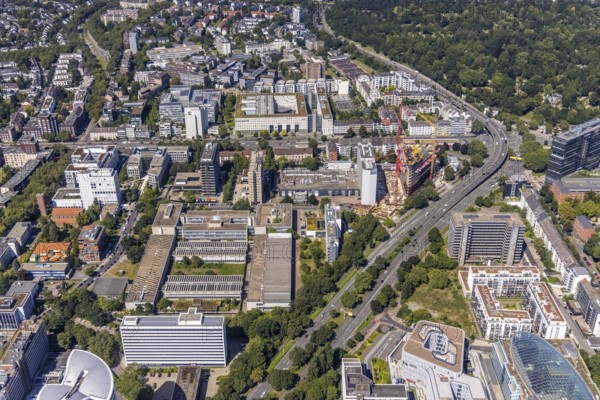 Aerial view, construction site and new construction of the three-storey Eclipse high-rise building next to the Hilton Hotel on Kennedydamm in the Golzheim district, Düsseldorf, Rhineland, North Rhine-Westphalia, Germany, construction work, construction area, construction site, building plots, construction project, construction site, DE, Europe, gastronomy, hotel, hotel facilities, hotel industry, aerial view, aerial photography, aerial photography, new construction, overview, bird's-eye view, overview