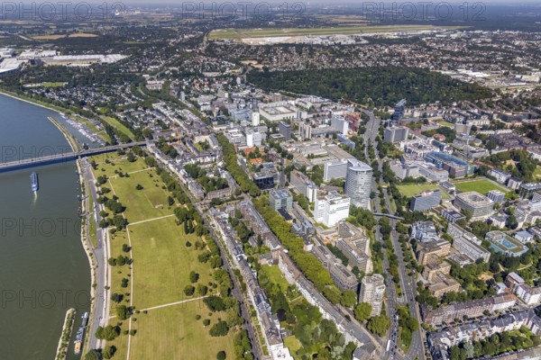 Aerial view, office centre between the Rheinaue and the Kennedydamm as well as construction site and new construction of the three-storey high-rise building Eclipse next to the Hilton Hotel on Kennedydamm in Golzheim, Düsseldorf, Rhineland, North Rhine-Westphalia, Germany, DE, Europe, aerial view, aerial photography, aerial photography, North Cemetery Düsseldorf in the forest, Rheinaue, overview, bird's-eye view, overview