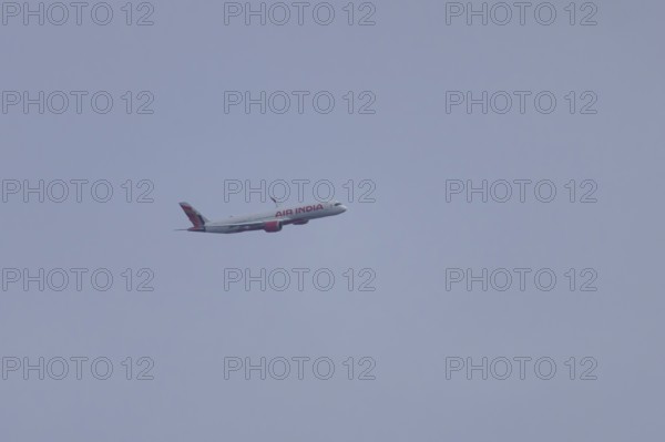 Aircraft of Air India airways in flight in a blue sky, London, England, United Kingdom