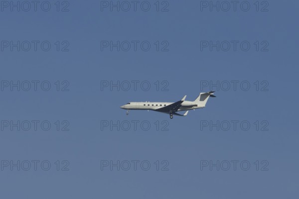 Executive business jet passenger aircraft in flight on approach to land, England, United Kingdom