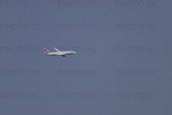 Boeing 787-9 Dreamliner jet passenger aircraft of British Airways airlines in flight in a blue sky, London, England, United Kingdom