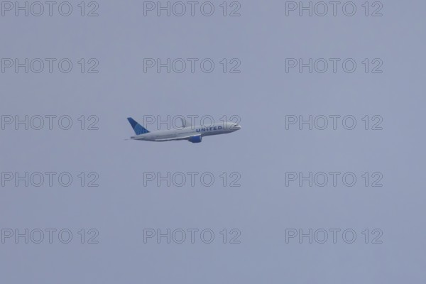 Jet passenger aircraft of United airways in flight in a blue sky, London, England, United Kingdom