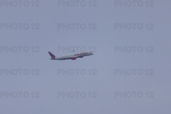 Airbus jet passenger aircraft of Air India airways in flight in a blue sky, London, England, United Kingdom