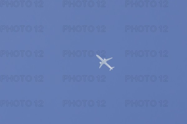 Airbus jet passenger aircraft flying in a blue sky, England, United Kingdom