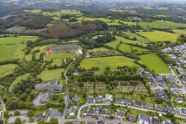 Aerial view, meadows and fields at Klevinghauser Straße between cemetery and sports field as well as St. Jacobus secondary school in Breckerfeld, Sauerland, North Rhine-Westphalia, Germany, burial site, education, educational institution, Breckerfeld, DE, Europe, cemetery, football pitch, memorial site, Gottesacker, graves, burial ground, educational institution, aerial photograph, aerial photography, aerial photography, resting place, school, sports facilities, sports field, sports facility, overview, bird's-eye view, overview