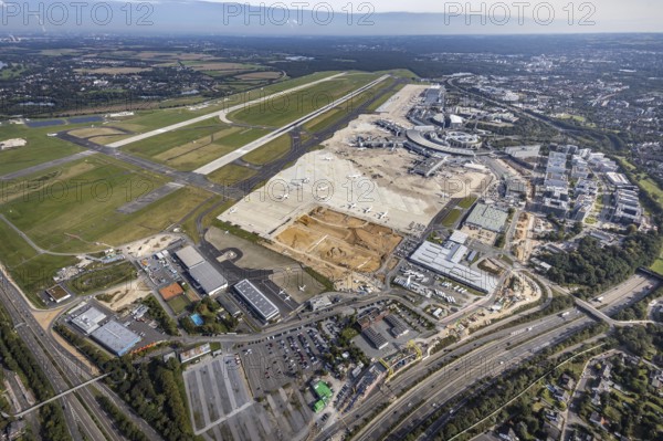 Aerial view, Düsseldorf Airport with construction site in the Lohausen district of Düsseldorf, Rhineland, North Rhine-Westphalia, Germany, construction work, construction area, construction site, building plots, construction project, construction site, DE, Düsseldorf, Europe, flight emission, airport, aircraft noise, airfield, aerial photograph, aerial photography, aerial photography, overview, bird's-eye view, bird's-eye view, overview
