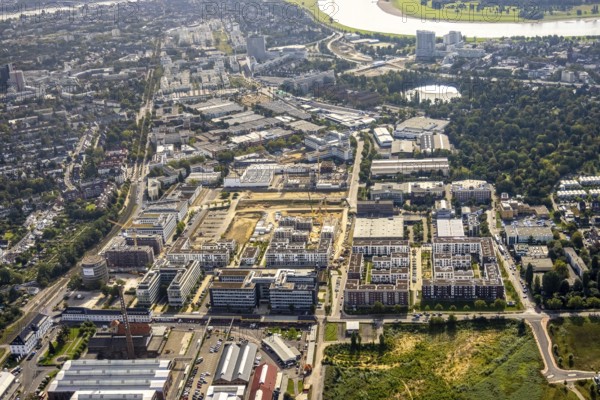 Aerial view, construction site at the VIERZIG549 residential complex and Hansapark Düsseldorf in the Büderich district of Meerbusch, Rhineland, North Rhine-Westphalia, Germany, construction work, construction area, building site, building plots, construction project, construction site, DE, Düsseldorf, Europe, shapes and colours, property tax, real estate, aerial view, aerial photography, aerial photography, Meerbusch, new building, overview, bird's-eye view, housing estate, housing and living, residential area, residential buildings, residential quality, residential quarter, housing estate, birds-eyes view, overview