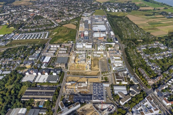 Aerial view, Areal Böhler commercial area and construction site at the VIERZIG549 residential complex and residential quarter Unter der Mühle in the Büderich district of Meerbusch, Rhineland, North Rhine-Westphalia, Germany, construction work, construction area, building site, building plots, construction project, construction site, DE, Düsseldorf, Europe, shapes and colours, commercial enterprises, commercial space, commercial area, commercial park, commercial location, commercial use, property tax, real estate, industrial area, industrial building, industrial location, aerial photograph, aerial photography, aerial photography, Meerbusch, new construction, overview, bird's-eye view, residential area, residential area, residential buildings, residential quality, residential neighbourhood, housing estate, birds-eyes view, overview