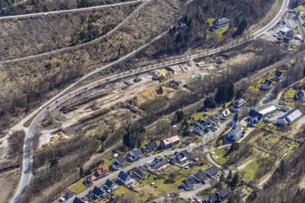Aerial view, old wood storage yard of the company Chemviron (demolished 20 years ago) . Chemviron (demolished 20 years ago), which is now used again as a wood storage area for bark beetle wood and wood chips for bio-heating plants, forest dieback, Brilon-Wald, Brilon, Sauerland, North Rhine-Westphalia, Germany, construction work, construction area, construction site, building plots, construction project, construction project, construction site, federal road B251, DE, renovation, vinegar tower, Europe, aerial view, aerial photography, aerial photography, North Rhine-Westphalia regional office Sauerland-Hochstift, renovation, redevelopment, tower, overview, bird's-eye view, overview