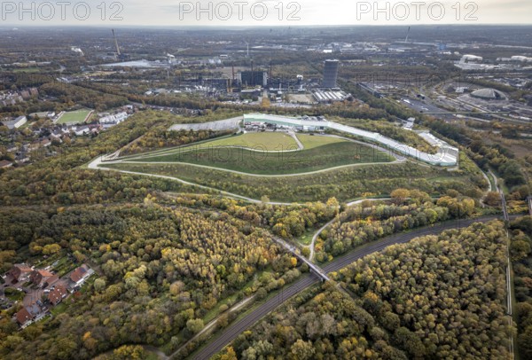 Aerial view, alpincenter Bottrop indoor ski centre on the Prosperstraße spoil tip and former Prosper-Haniel mine, now ArcelorMittal Bottrop in the Welheim district of Bottrop, Ruhr area, North Rhine-Westphalia, Germany, Prosper-Haniel spoil tip, Prosper-Haniel mine, Bottrop, DE, Europe, leisure facility, leisure activities, leisure park, slag heap, slag heap Prosperstraße, slag heap landscape, aerial view, aerial photography, aerial photography, sight, ski hall, overview, bird's-eye view, winter sports facility, colliery, birds-eyes view, overview