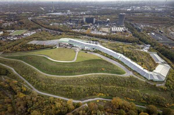 Aerial view, alpincenter Bottrop indoor ski centre on the Prosperstraße spoil tip and former Prosper-Haniel mine, now ArcelorMittal Bottrop in the Welheim district of Bottrop, Ruhr area, North Rhine-Westphalia, Germany, Prosper-Haniel spoil tip, Prosper-Haniel mine, Bottrop, DE, Europe, leisure facility, leisure activities, leisure park, slag heap, slag heap Prosperstraße, slag heap landscape, aerial view, aerial photography, aerial photography, sight, ski hall, overview, bird's-eye view, winter sports facility, colliery, birds-eyes view, overview