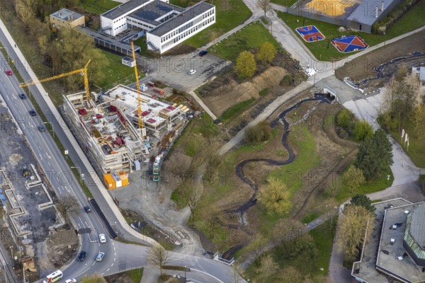 Aerial view, construction site and new construction of vocational training centre on the educational campus on Kleinbahnstraße, Hüsten, Arnsberg, Sauerland, North Rhine-Westphalia, Germany, construction work, construction area, building site, building plots, construction project, construction site, education, educational institution, DE, Europe, teaching institute, aerial view, aerial photography, aerial photography, new construction, school, overview, bird's-eye view, overview, new course of stream, tree stream