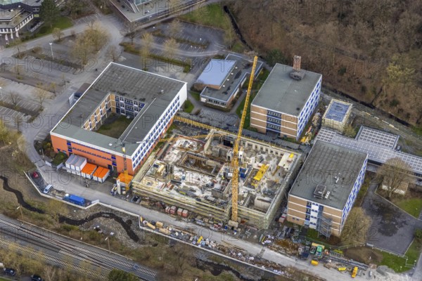 Aerial view, construction site and new building at Berufskolleg Berliner Platz, Hüsten, Arnsberg, Sauerland, North Rhine-Westphalia, Germany, construction work, construction area, construction site, building plots, construction crane, construction measure, construction project, construction site, education, educational institution, DE, Europe, college school, teaching institute, aerial view, aerial photography, aerial photography, new building, school, overview, bird's-eye view, overview