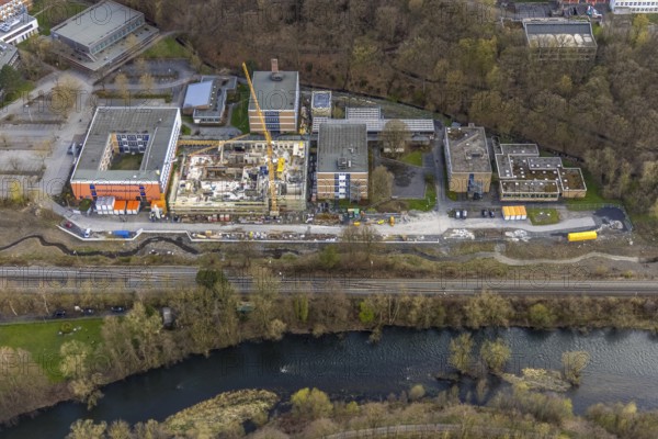 Aerial view, construction site and new building at Berufskolleg Berliner Platz, Hüsten, Arnsberg, Sauerland, North Rhine-Westphalia, Germany, construction work, construction area, construction site, building plots, construction crane, construction measure, construction project, construction site, education, educational institution, DE, Europe, college school, teaching institute, aerial view, aerial photography, aerial photography, new building, school, overview, bird's-eye view, overview, new course of stream, tree stream