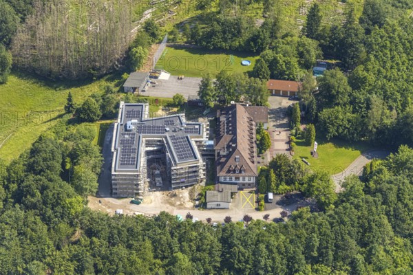 Aerial view, construction site and new building for the children's home Marienfrieden, SkF Hochsauerland Sozialdienst kath. Frauen e.V., Hüsten, Arnsberg, Sauerland, North Rhine-Westphalia, Germany, construction work, construction area, building site, building plots, construction project, construction site, DE, Europe, Haus Marienfrieden, Hochsauerlandkreis, children's home, aerial photograph, aerial photography, aerial photography, new building, photovoltaics, photovoltaic system, SkF Hochsauerland, solar, solar system, solar energy, solar energy, overview, bird's-eye view, birds-eyes view, overview