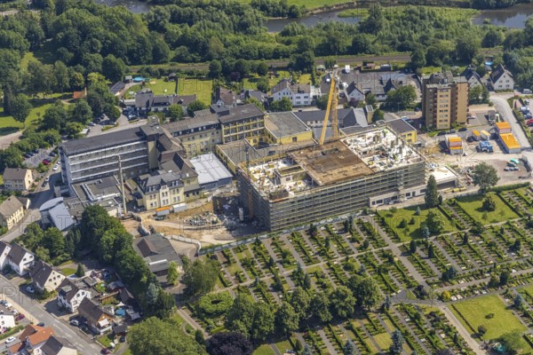 Aerial view, construction site and extension of Hochsauerland Karolinen-Hospital Hüsten, Hüsten, Arnsberg, Sauerland, North Rhine-Westphalia, Germany, construction work, construction area, building site, building plots, construction project, construction site, DE, Europe, health care, Hochsauerlandkreis, hospital, clinic, clinic centre, hospital, aerial photograph, aerial photography, aerial photography, medical facility, medical aid, new building, overview, bird's eye view, birds-eyes view, overview, medical care