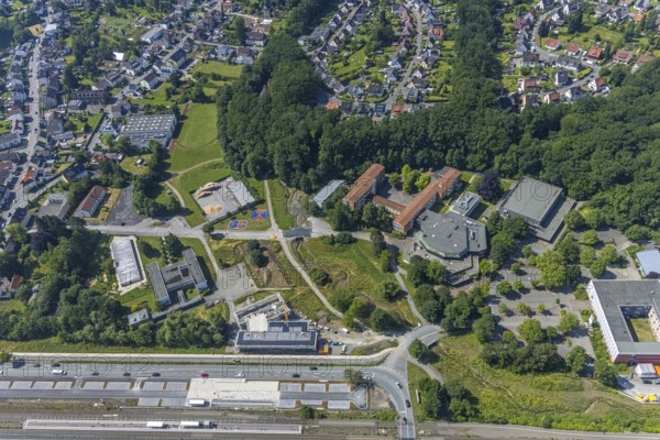 Aerial view, construction site, new building extension for Hochsauerlandkreis vocational college, Neheim-Hüsten station, Berliner Platz cultural centre, Franz-Stock-Gymnasium, Sauerland-Kolleg Arnsberg, Hüsten, Arnsberg, Sauerland, North Rhine-Westphalia, Germany, railway tracks, station, platform, construction work, construction site, building site, construction project, building site, education, educational institution, DE, Deutsche Bahn AG, Europe, grammar school, main railway station, main station, Hochsauerlandkreis, college, teaching institute, aerial view, aerial photography, aerial photography, new building, school, overview, bird's-eye view, overview