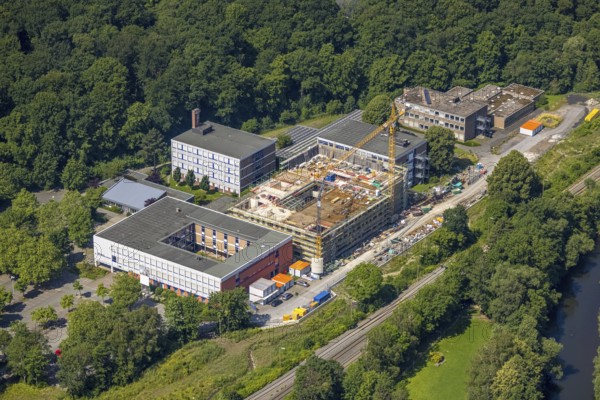 Aerial view, construction site and new building, Berufskolleg Berliner Platz, Hüsten, Arnsberg, Sauerland, North Rhine-Westphalia, Germany, construction work, construction area, construction site, building plots, construction crane, construction measure, construction project, construction site, education, educational institution, DE, Europe, Hochsauerlandkreis, college school, teaching institute, aerial view, aerial photography, aerial photography, new building, school, overview, bird's-eye view, overview