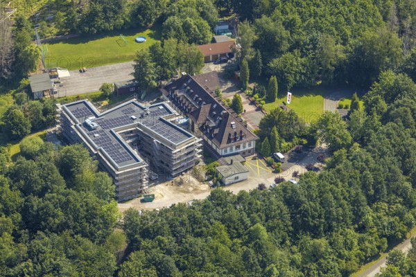 Aerial view, construction site and new building for the children's home Marienfrieden, SkF Hochsauerland Sozialdienst kath. Frauen e.V., Hüsten, Arnsberg, Sauerland, North Rhine-Westphalia, Germany, construction work, construction area, building site, building plots, construction project, construction site, DE, Europe, Haus Marienfrieden, Hochsauerlandkreis, children's home, aerial photograph, aerial photography, aerial photography, new building, photovoltaics, photovoltaic system, SkF Hochsauerland, solar, solar system, solar energy, solar energy, overview, bird's-eye view, birds-eyes view, overview
