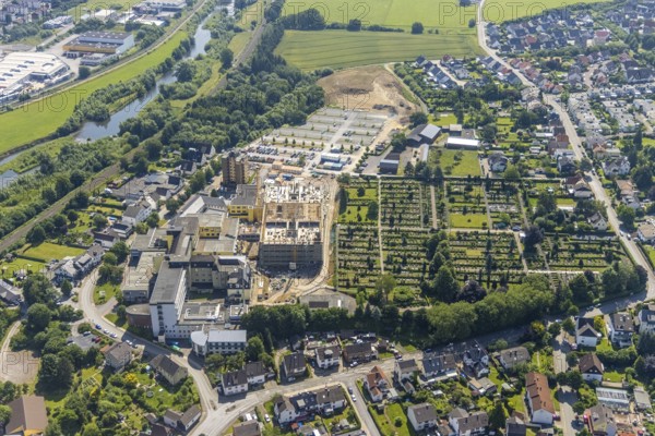 Aerial view, construction site and extension of Hochsauerland Karolinen-Hospital Hüsten, Hüsten, Arnsberg, Sauerland, North Rhine-Westphalia, Germany, construction work, construction area, building site, building plots, construction project, construction site, burial site, DE, Europe, cemetery, memorial, health care, Gottesacker, graves, burial ground, Hochsauerlandkreis, hospital, Kath. St. Petri cemetery, clinic, hospital, hospital centre, hospital, aerial view, aerial photography, aerial photography, medical facility, medical aid, new building, resting place, overview, bird's-eye view, bird's-eye view, overview, medical care