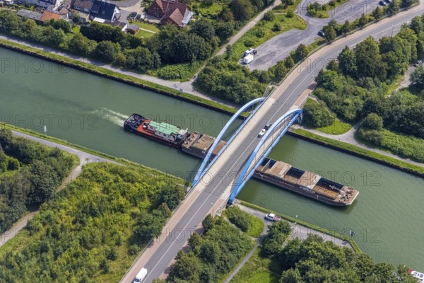 Aerial view, cargo ship on the Datteln-Hamm canal at the Werner Straße bridge in Rünthe, Bergkamen, Ruhr area, North Rhine-Westphalia, Germany, inland navigation, federal road B233, DE, Europe, goods transport, goods traffic, cargo ships, aerial view, aerial photography, aerial photography, shipping, shipping traffic, overview, bird's eye view, Werner Straße bridge, birds-eyes view, overview
