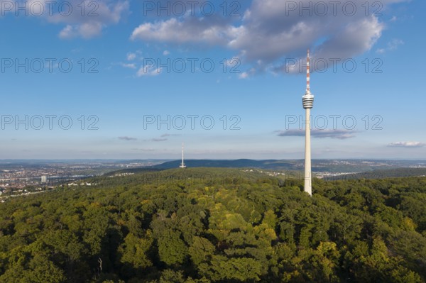 Modern television tower above a green forest and soft clouds in the blue sky, Stuttgart-Degerloch, Baden-Württemberg, Germany