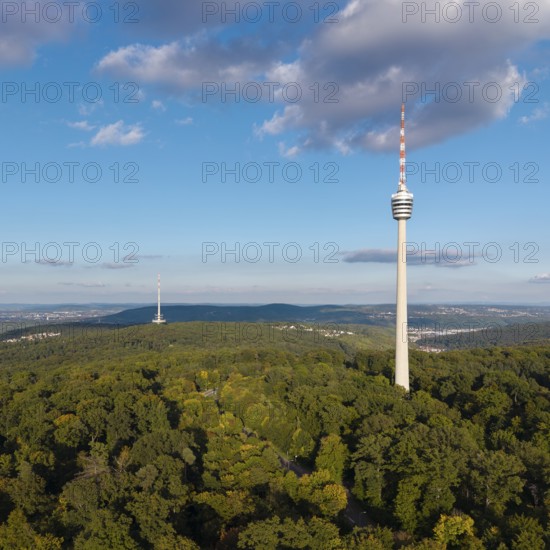 View of the television tower above a green forest under a blue sky with soft clouds, Stuttgart-Degerloch, Baden-Württemberg, Germany