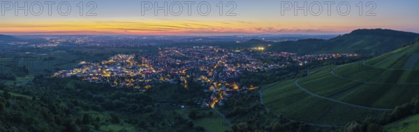 Town at sunset with illuminated streets and surrounding hills in twilight, Korb im Remstal, Baden-Württemberg, Germany