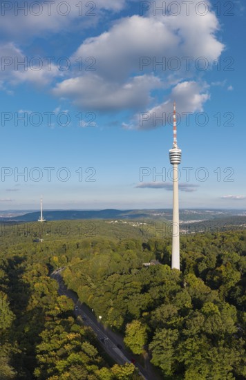 View of a television tower above a dense forest, surrounded by soft clouds in the sky, Stuttgart-Degerloch, Baden-Württemberg, Germany