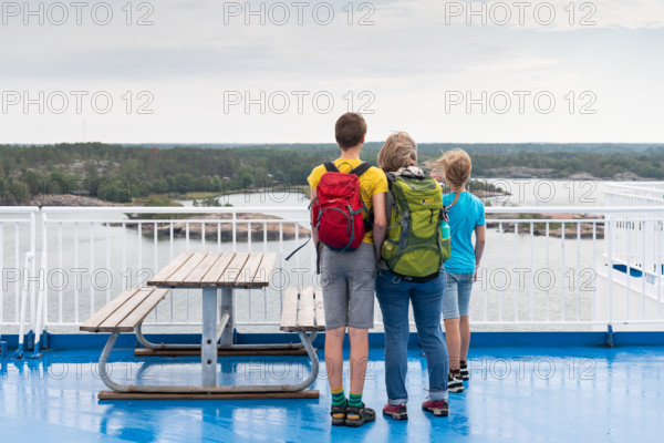 Mother with two children standing on the deck of a ferry, Åland, Åland Islands, Finland