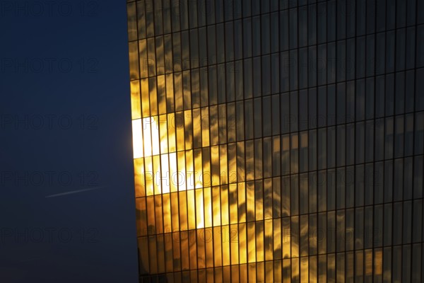 The light of the setting sun is reflected in the glass façade of the European Central Bank (ECB) in Frankfurt am Main, Osthafen, Frankfurt am Main, Hesse, Germany