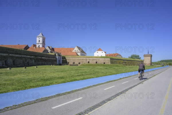 Fortress with church tower and cycle path and blue tread in the foreground, Tvrda, Osijek, Osijek-Baranja County, Croatia