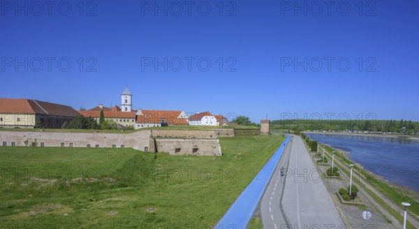 Fortress with church tower and cycle path and blue tread in the foreground, Tvrda, Osijek, Osijek-Baranja County, Croatia