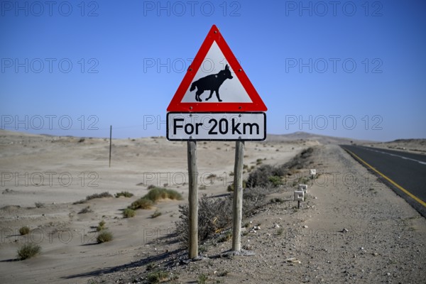 Sign warning of brown hyenas or beach wolves (Parahyaena brunnea), near Lüderitz, Karas Region, Namibia