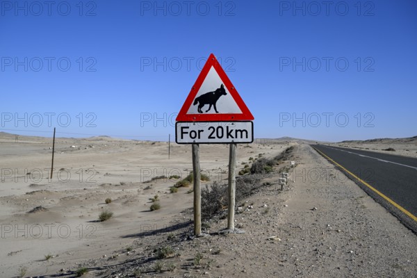 Sign warning of brown hyenas or beach wolves (Parahyaena brunnea), near Lüderitz, Karas Region, Namibia